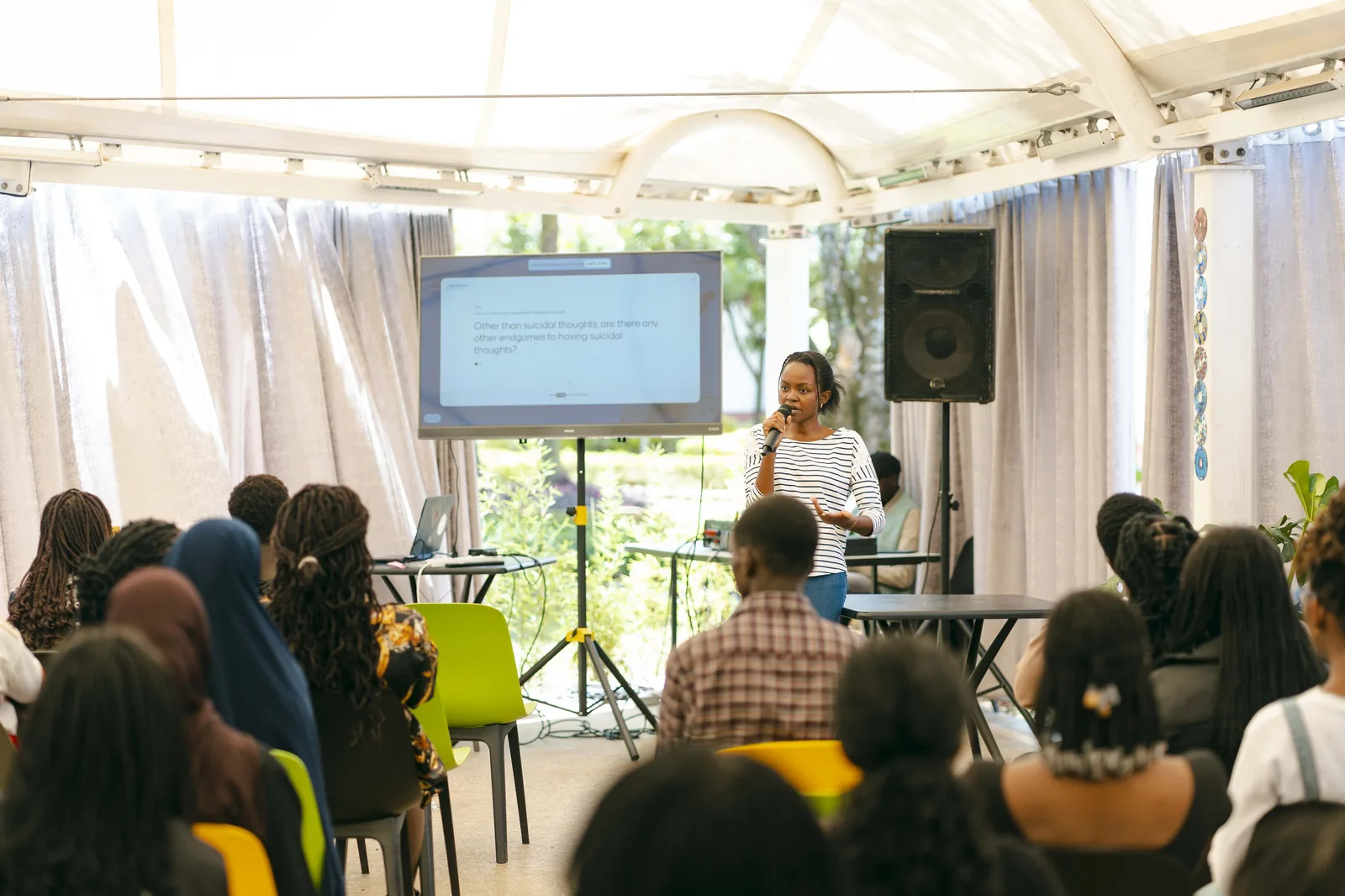 A full room of students at a Heyrafiki wellbeing talk, seen from behind
