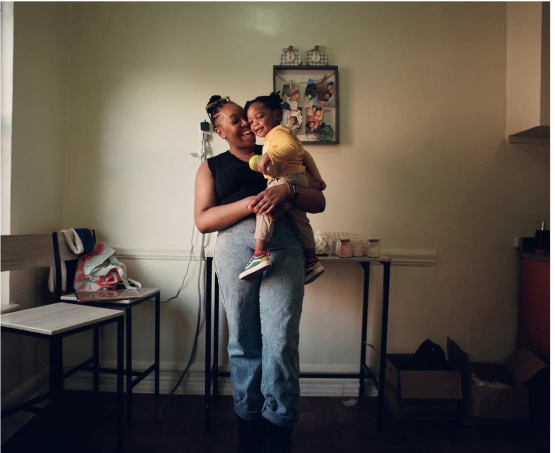 A mother holding her young child at home