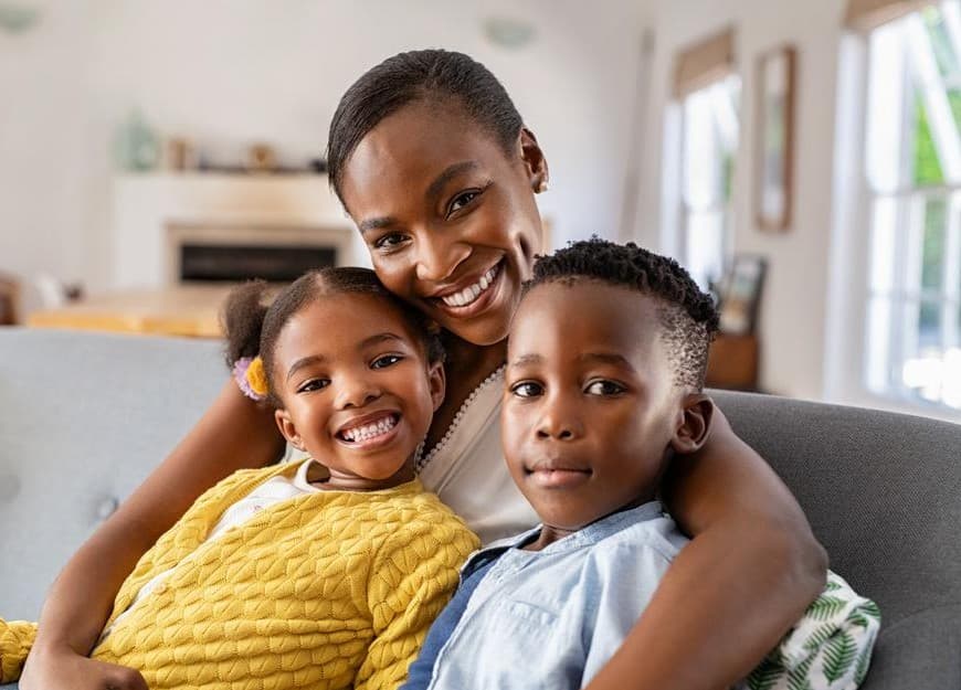 A mother and her two children at home, the people a Benefit is meant to reach